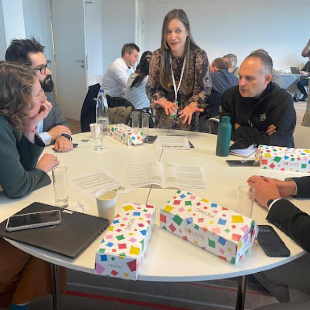 Drastic World Economic Forum workshop - group around a table discussing.